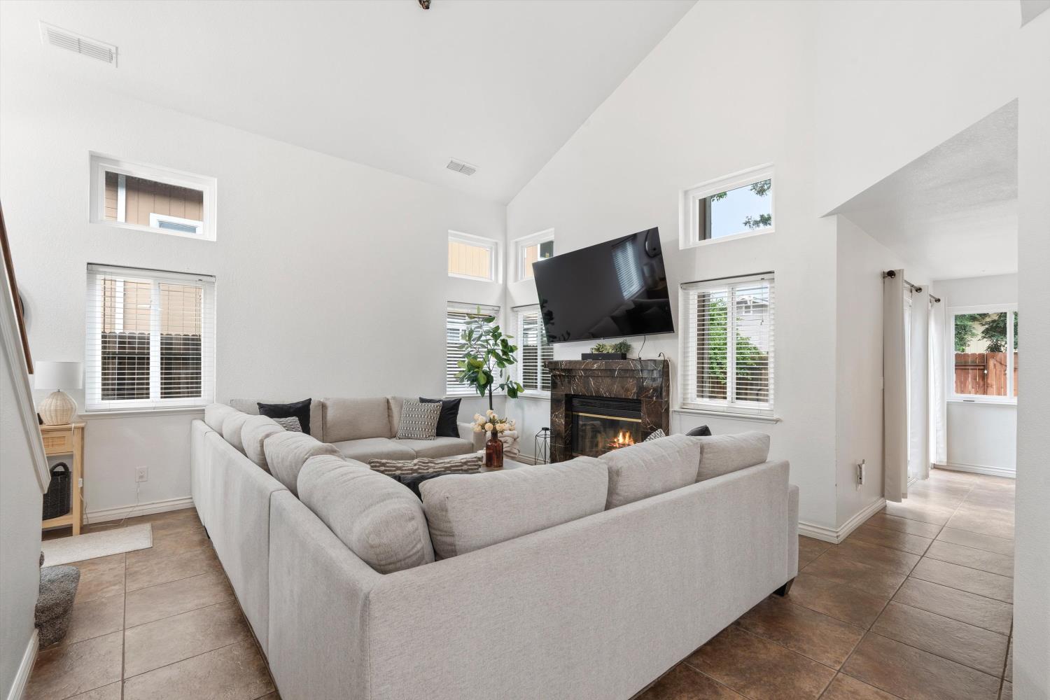 8117 Prior Way Antelope, CA 95843 - Photo 6 of 27 a living room with furniture a fireplace and a flat screen tv
