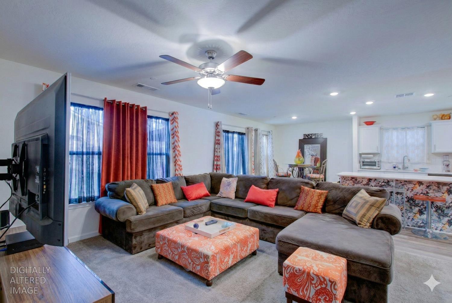 295 Bryce Cyn Court Merced, CA 95341 - Photo 7 of 21 a living room with furniture ceiling fan and a rug