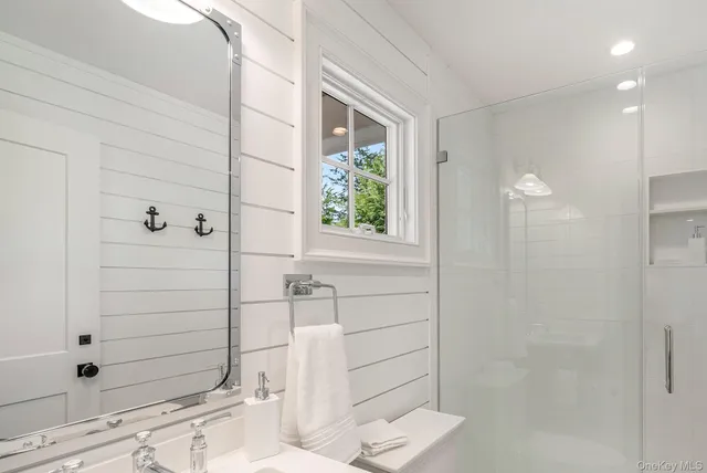 a hallway with white cabinets and wooden floor