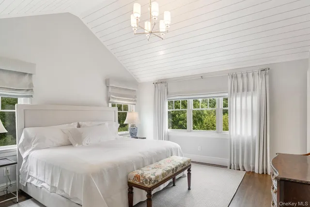 a spacious bedroom with a bed and a window