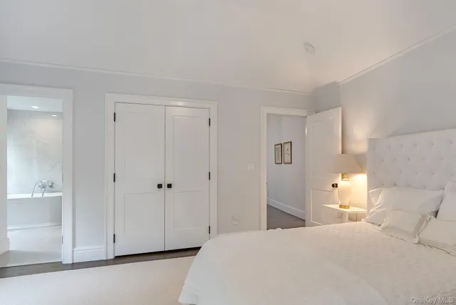 a bedroom with a bed and white cabinets