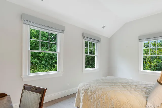 a bed sitting in a bedroom next to a window