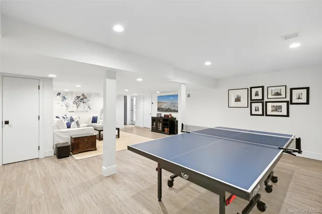 a living room with furniture a table and wooden floor
