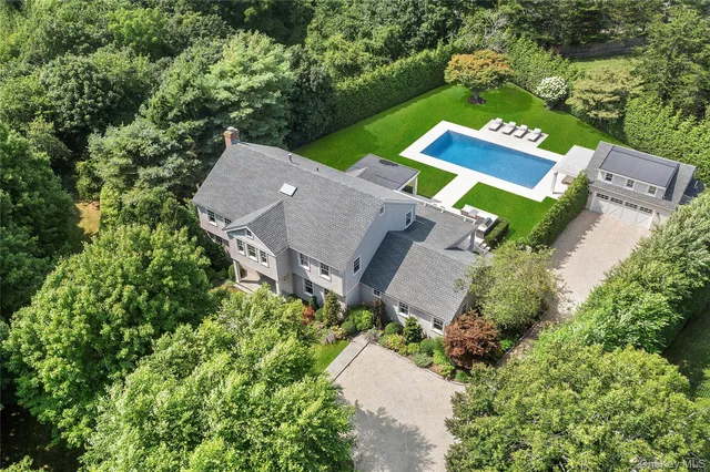 an aerial view of a house with a garden and trees