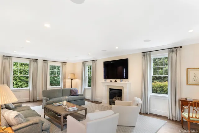 a living room with furniture a fireplace and a flat screen tv