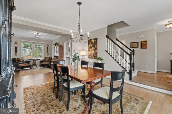 a kitchen with stainless steel appliances a stove a sink a oven a dining table and chairs
