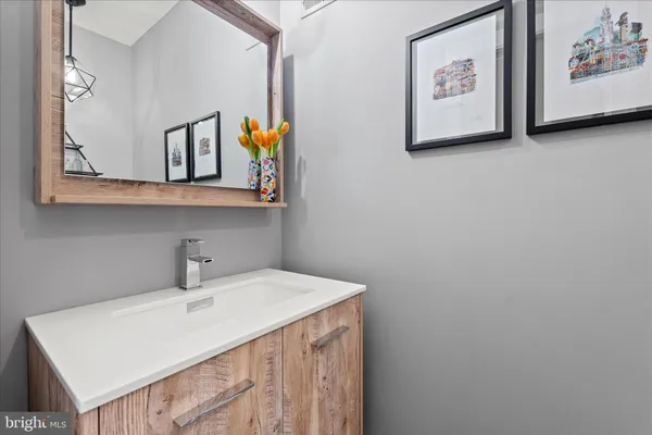 a bathroom with a granite countertop sink a mirror and a bathtub