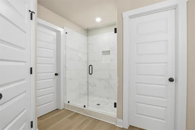 a bathroom with a glass shower door