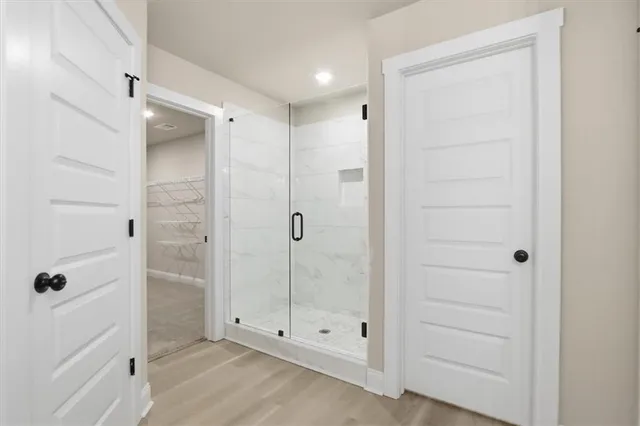 a view of walk in closet with empty racks