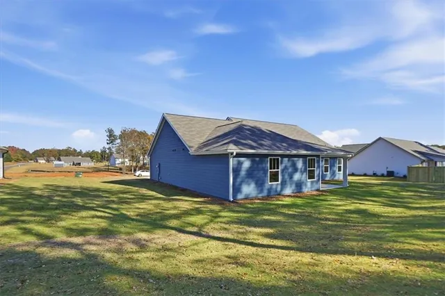 a view of house with backyard