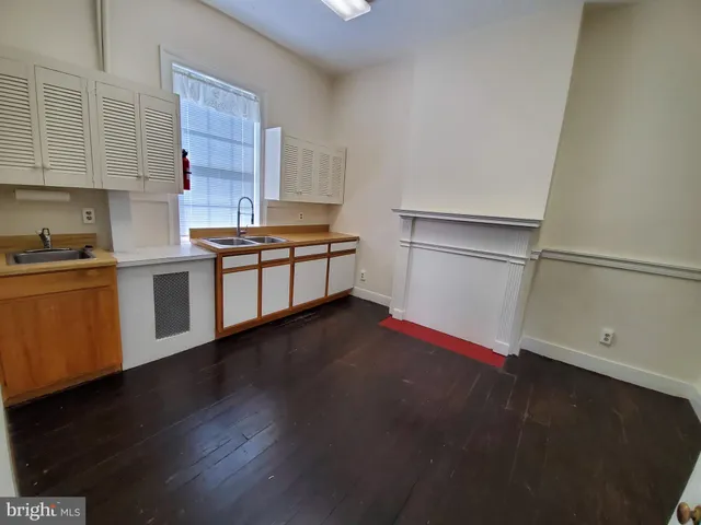 a kitchen with granite countertop a stove and a refrigerator