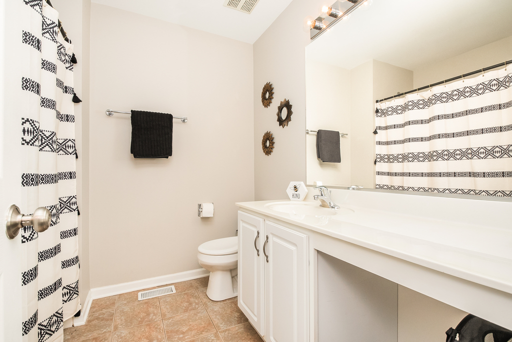 2518 Golf Ridge Circle, Unit 2518 Naperville, IL 60563 - Photo 11 of 25 a bathroom with a sink toilet a mirror and shower