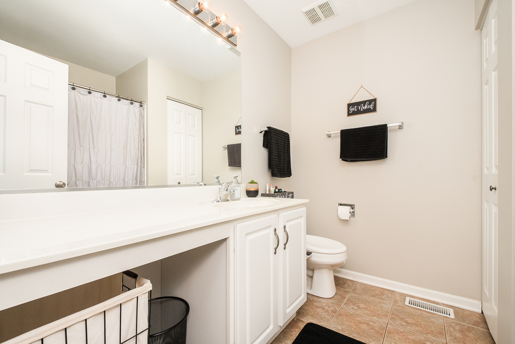 2518 Golf Ridge Circle, Unit 2518 Naperville, IL 60563 - Photo 13 of 25 a bathroom with a sink a toilet and a mirror