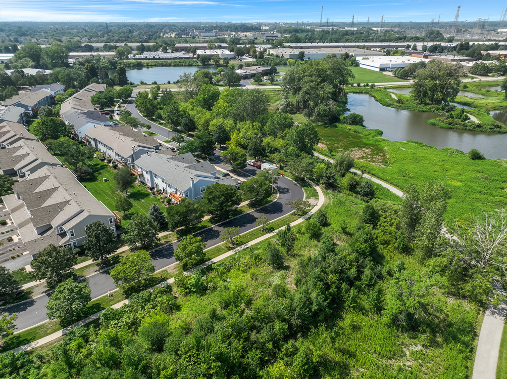 2518 Golf Ridge Circle, Unit 2518 Naperville, IL 60563 - Photo 24 of 25 an aerial view of green landscape with trees houses and lake view