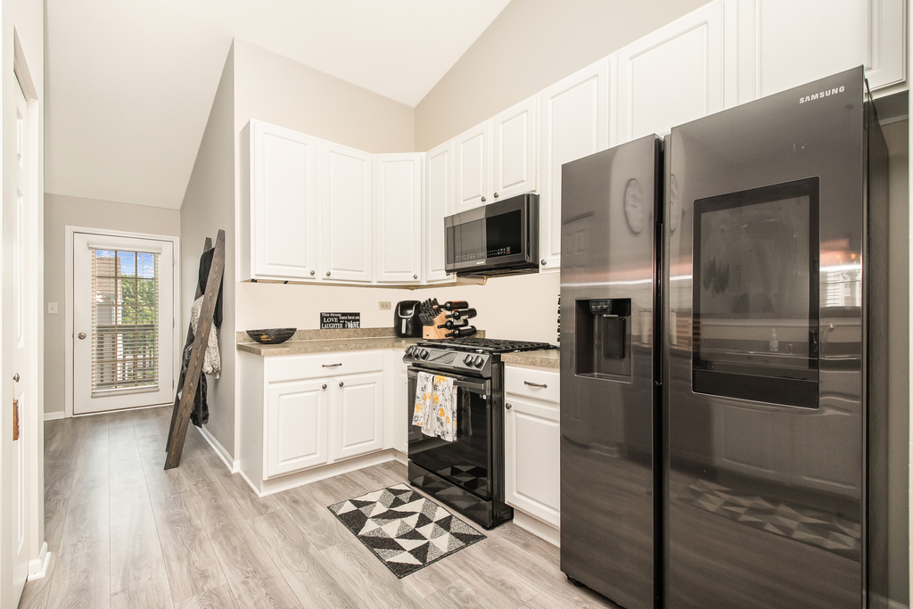2518 Golf Ridge Circle, Unit 2518 Naperville, IL 60563 - Photo 6 of 25 a kitchen with stainless steel appliances a stove a sink and a refrigerator
