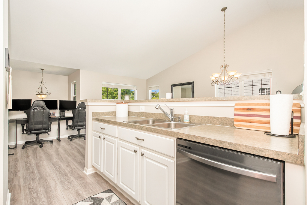 2518 Golf Ridge Circle, Unit 2518 Naperville, IL 60563 - Photo 7 of 25 a kitchen with a sink dishwasher and white cabinets with wooden floor