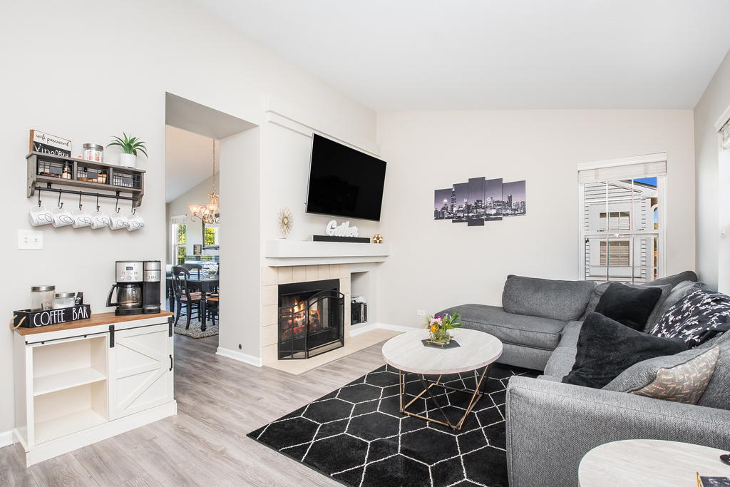 2518 Golf Ridge Circle, Unit 2518 Naperville, IL 60563 - Photo 8 of 25 a living room with furniture a fireplace and a flat screen tv