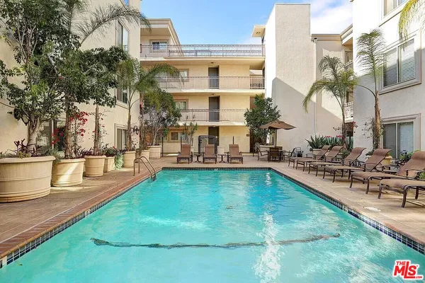 a view of a swimming pool with outdoor seating