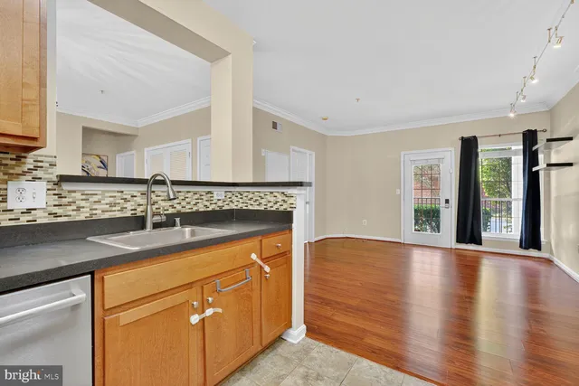 a view of a kitchen with a refrigerator and a stove top oven