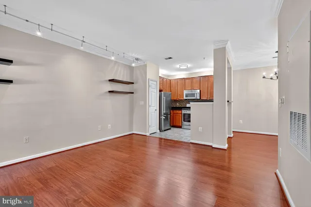 a view of a kitchen with wooden floor and a kitchen