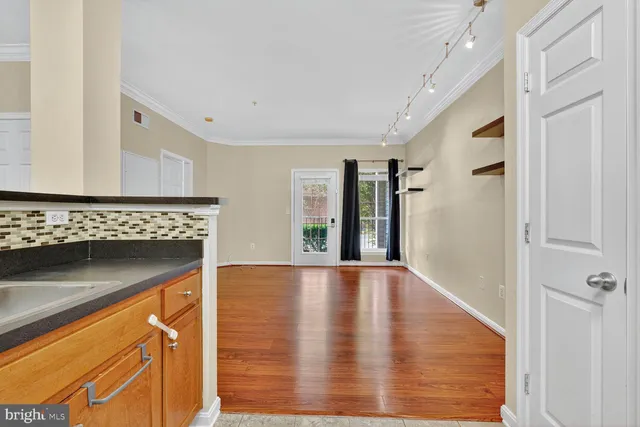 a view of an empty room with glass door and a window