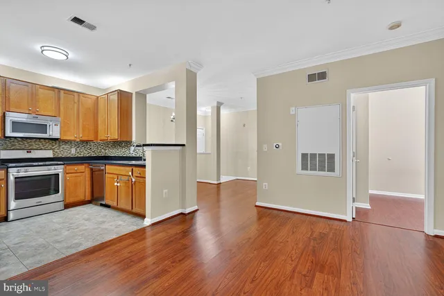 a kitchen with granite countertop a sink and cabinets