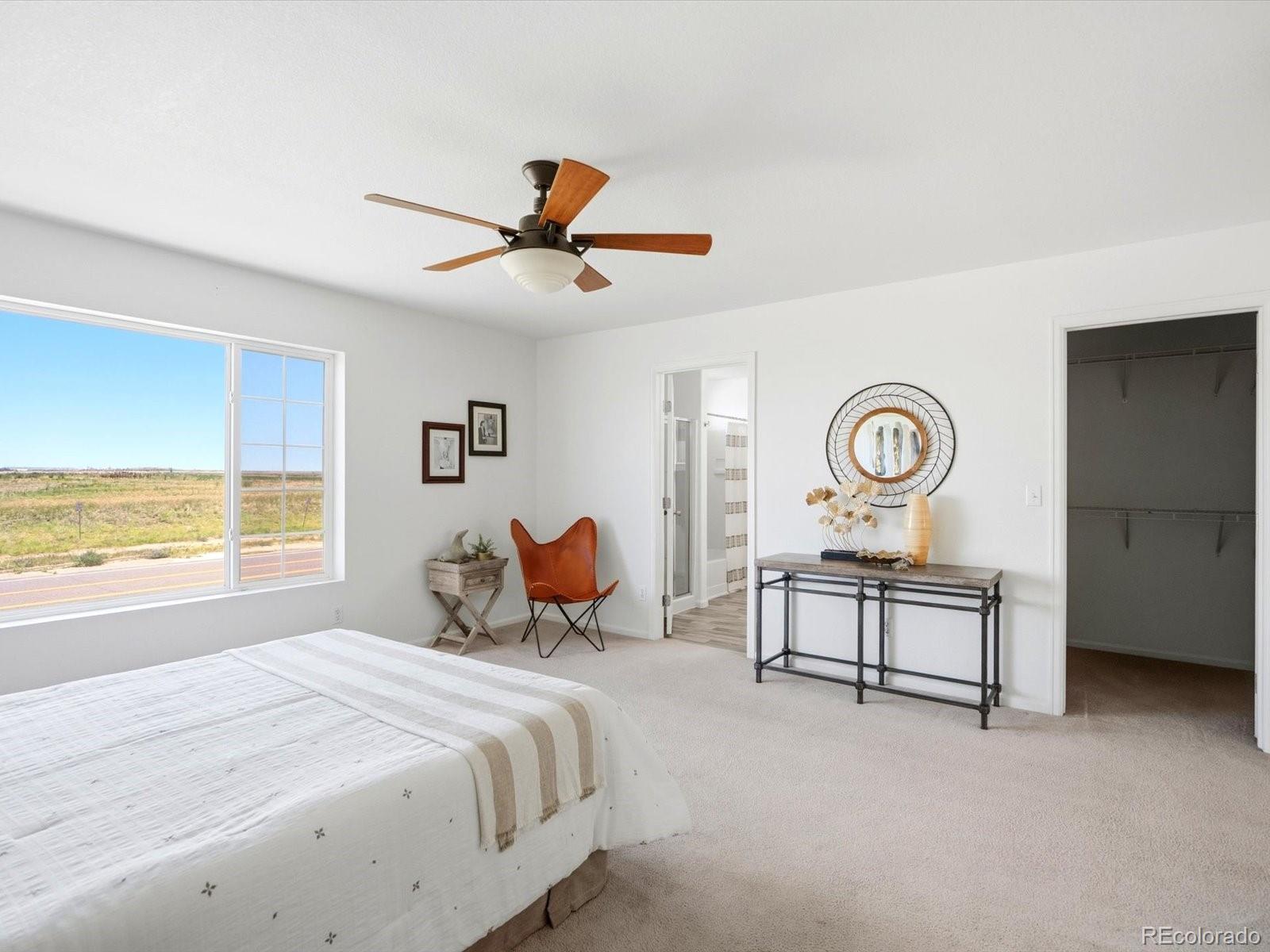 5444 Perth Court Denver, CO 80249 - Photo 27 of 46 a bedroom with a bed and a table