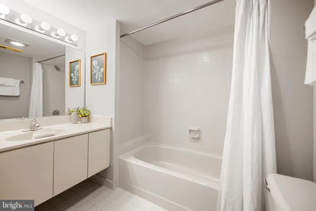 a bedroom with a bed and a night stand