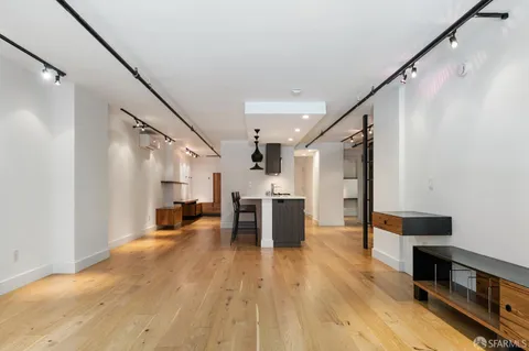 a view of kitchen with furniture and wooden floor