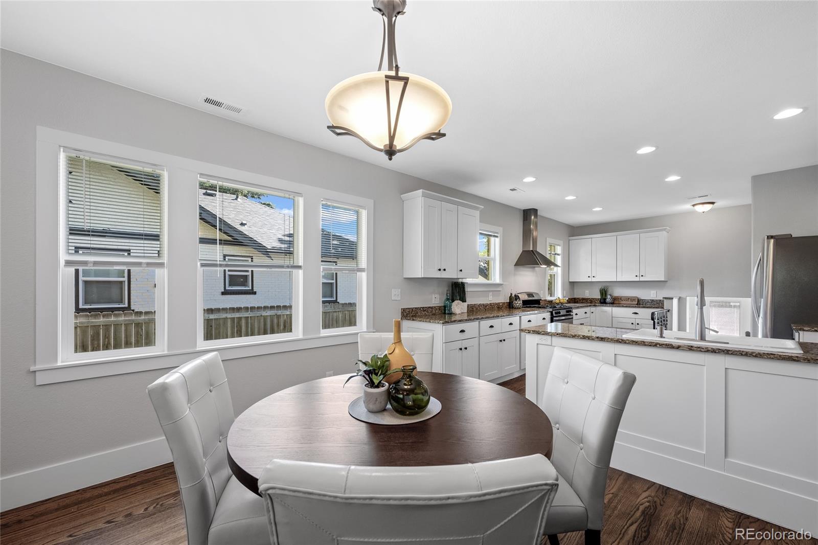 2829 Ash Street Denver, CO 80207 - Photo 12 of 40 a kitchen with dining table and chairs