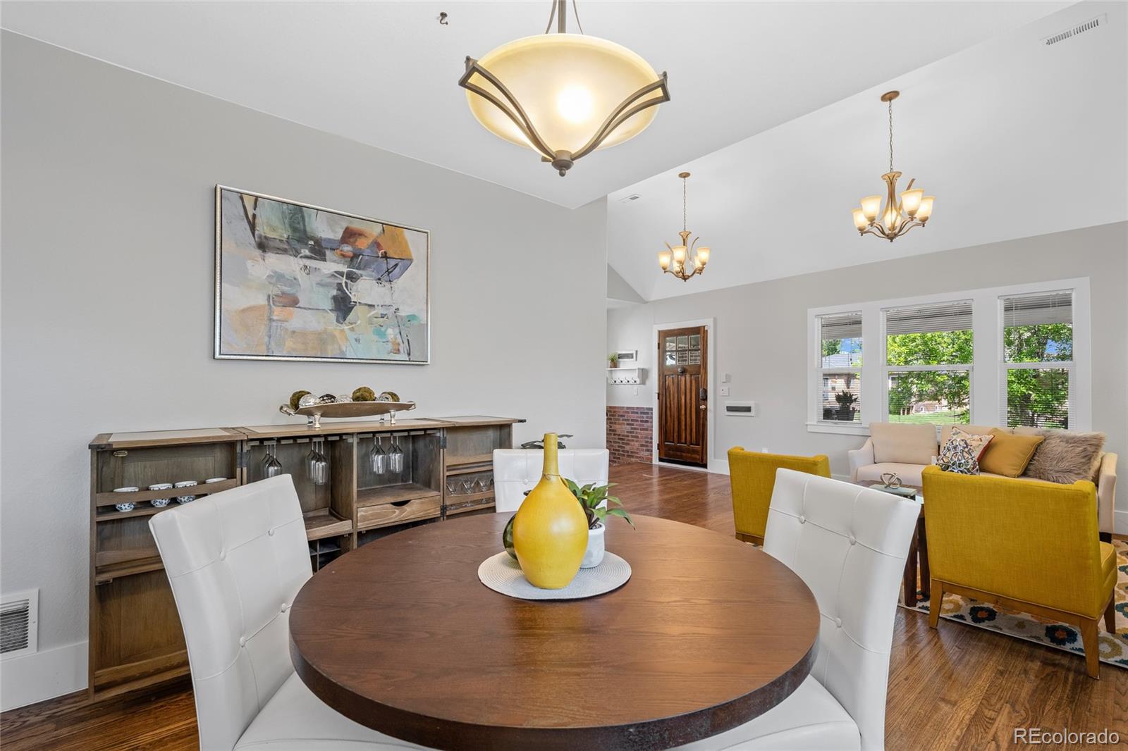 2829 Ash Street Denver, CO 80207 - Photo 13 of 40 a view of a dining room with furniture window and wooden floor