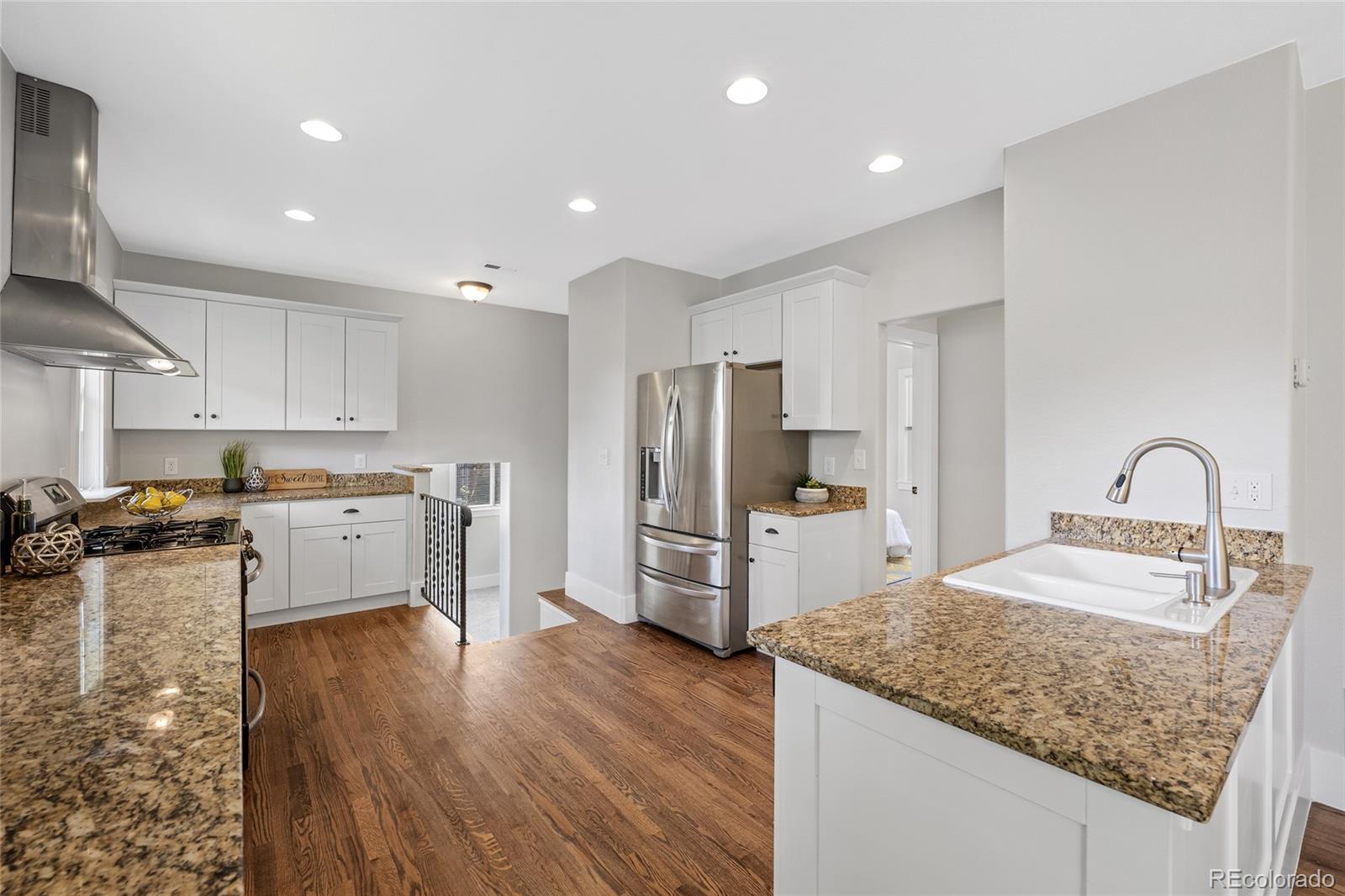 2829 Ash Street Denver, CO 80207 - Photo 15 of 40 a kitchen with refrigerator and cabinets
