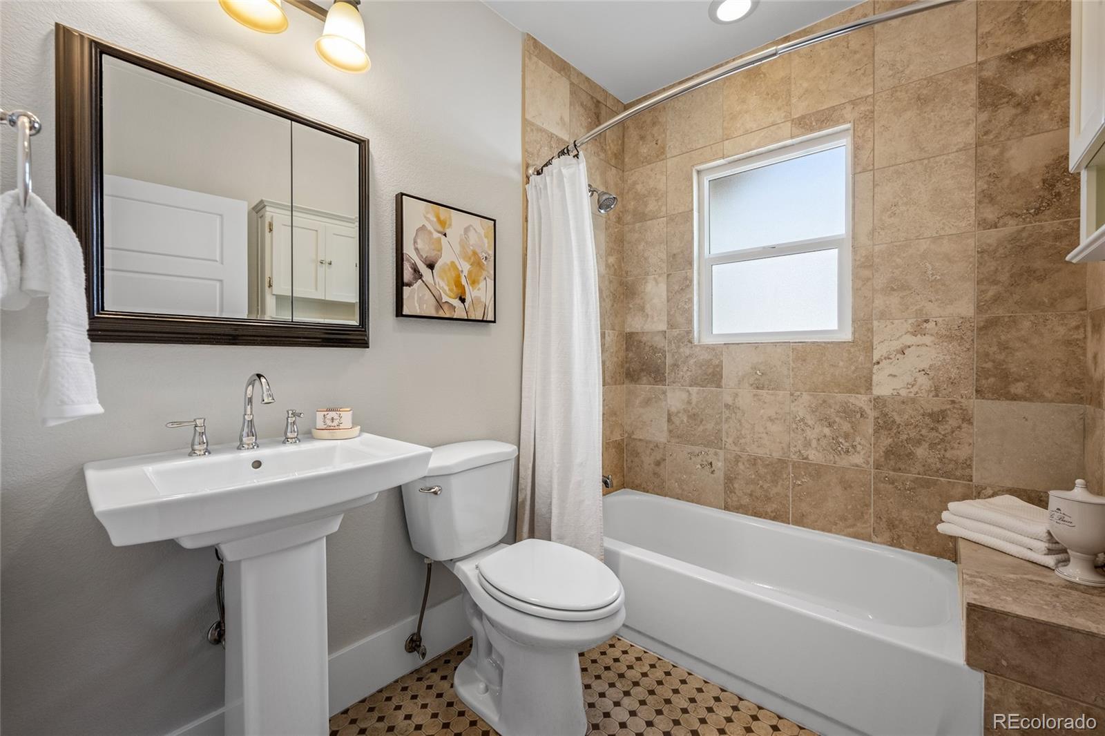 2829 Ash Street Denver, CO 80207 - Photo 18 of 40 a bathroom with a sink toilet and shower