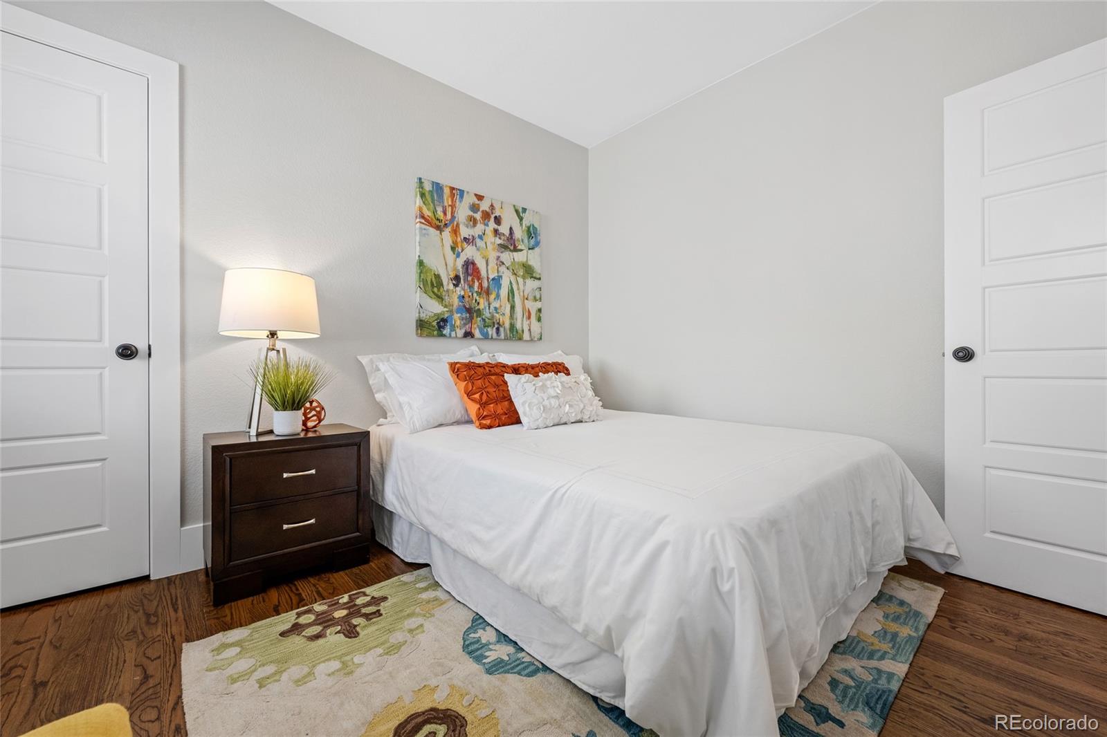 2829 Ash Street Denver, CO 80207 - Photo 19 of 40 a bedroom with a bed and a dresser