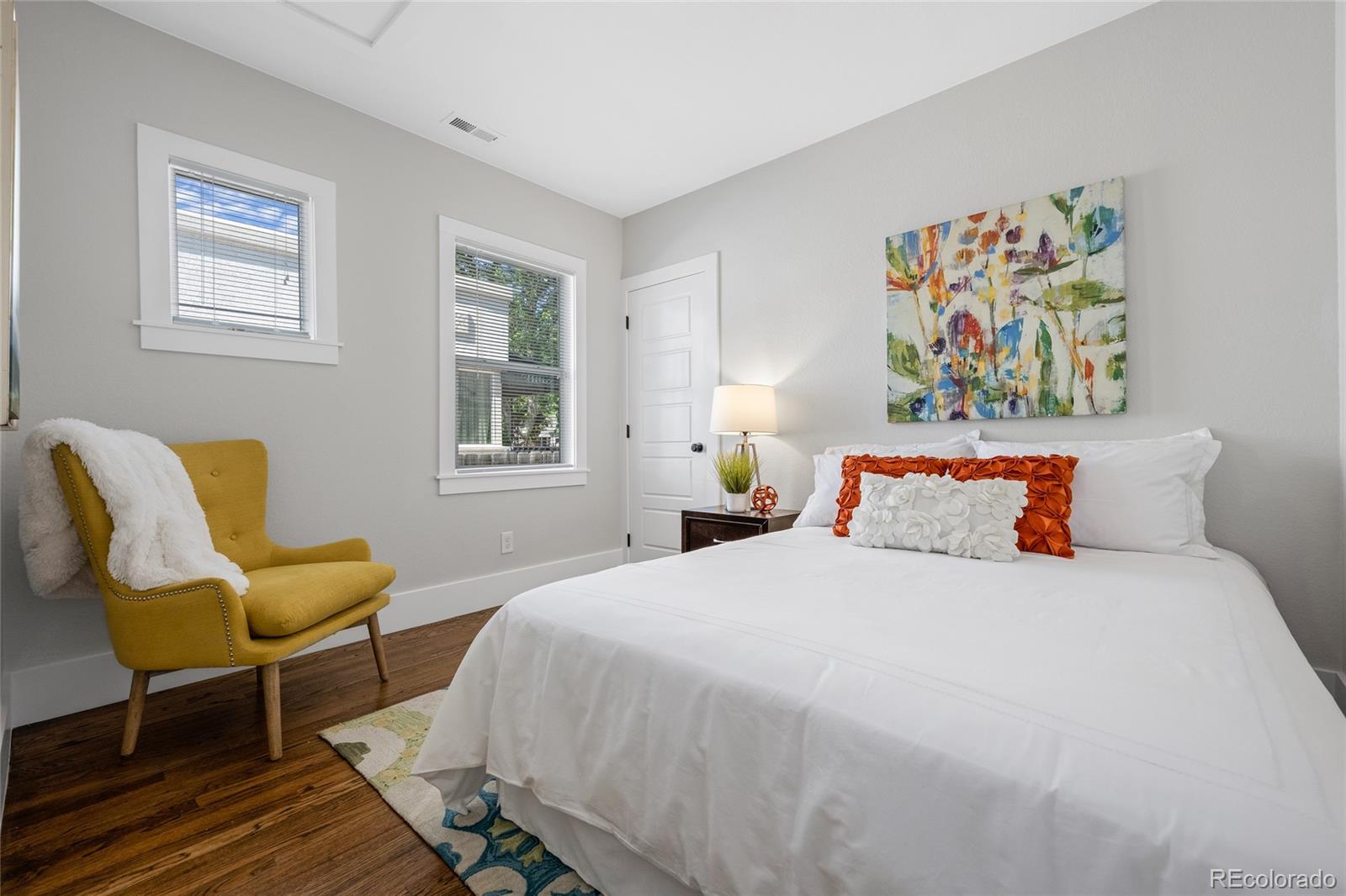 2829 Ash Street Denver, CO 80207 - Photo 20 of 40 a bedroom with a bed and furniture