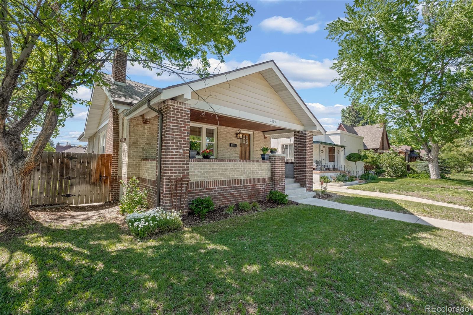 2829 Ash Street Denver, CO 80207 - Photo 2 of 40 a view of a house with a yard