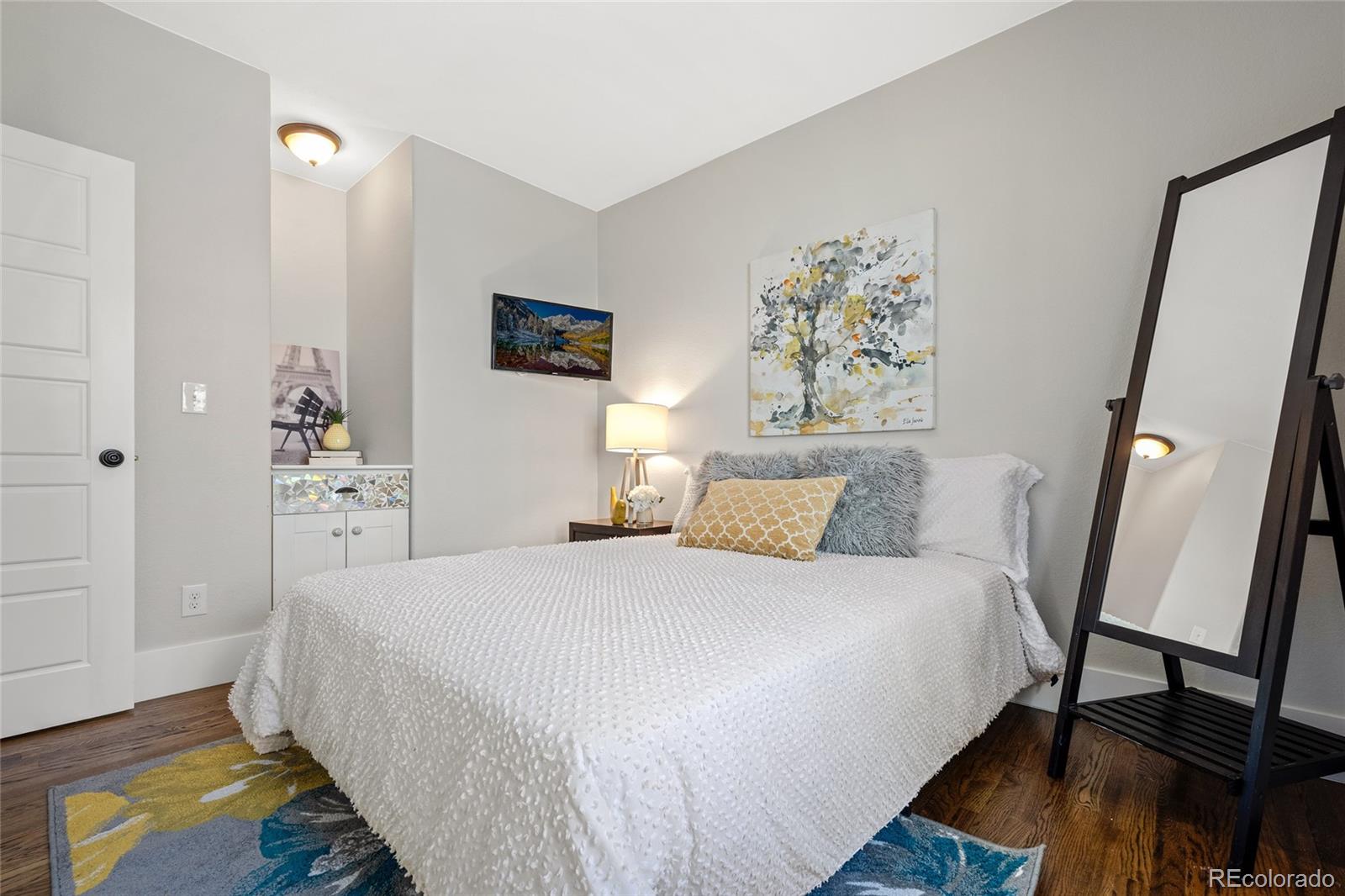 2829 Ash Street Denver, CO 80207 - Photo 22 of 40 a bedroom with a bed and a dresser