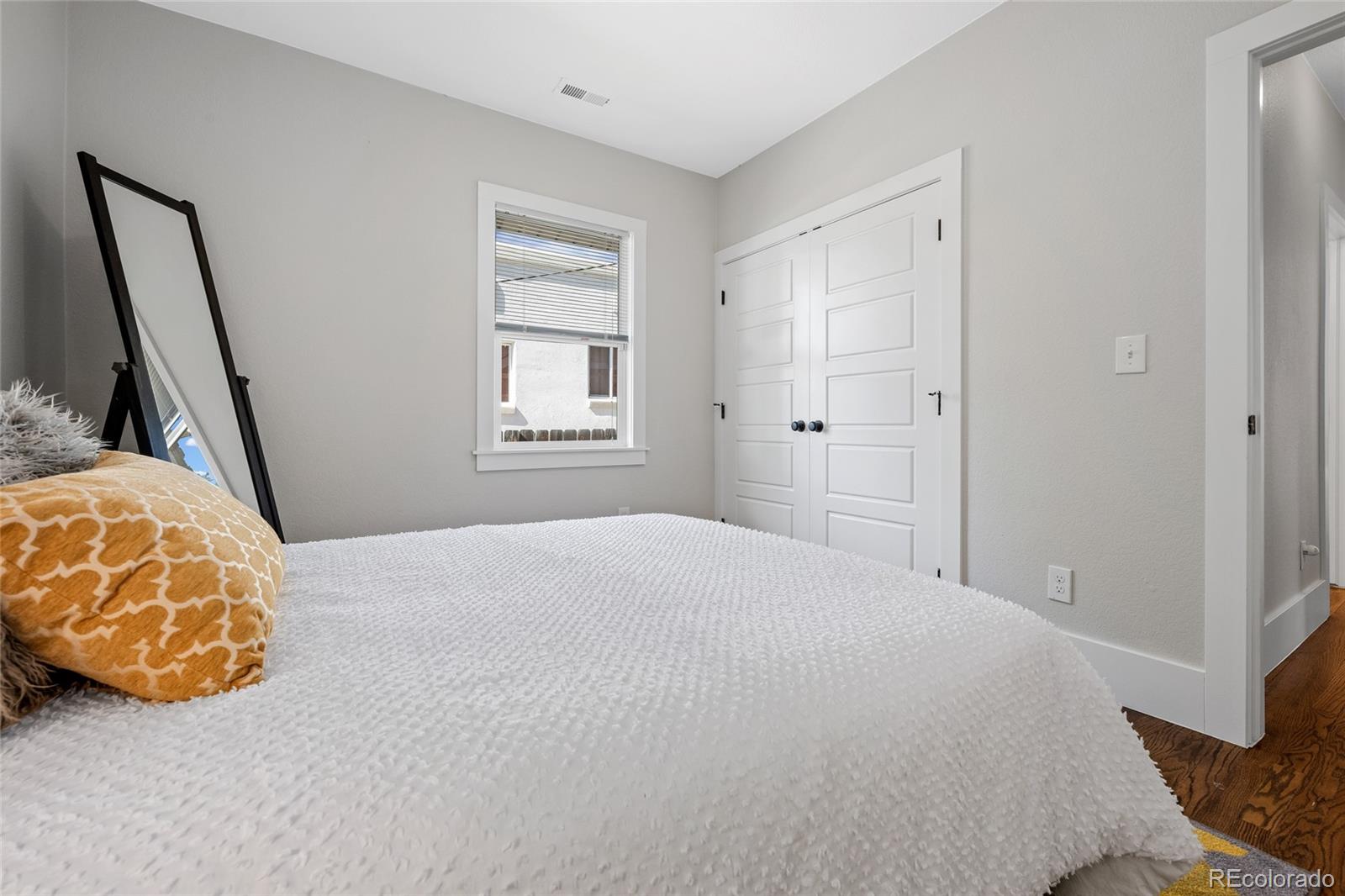 2829 Ash Street Denver, CO 80207 - Photo 23 of 40 a bedroom with a bed and a window