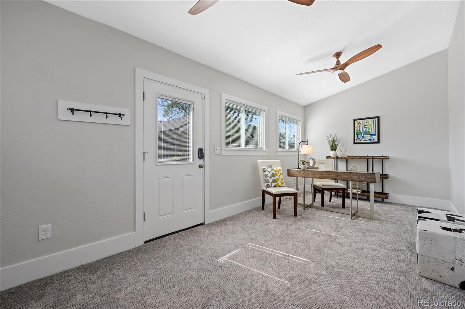 2829 Ash Street Denver, CO 80207 - Photo 24 of 40 a view of a livingroom with furniture and windows