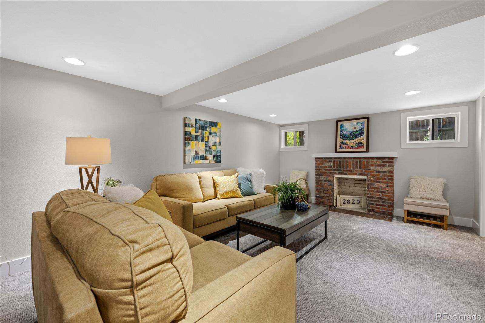2829 Ash Street Denver, CO 80207 - Photo 27 of 40 a bedroom with furniture and a lamp