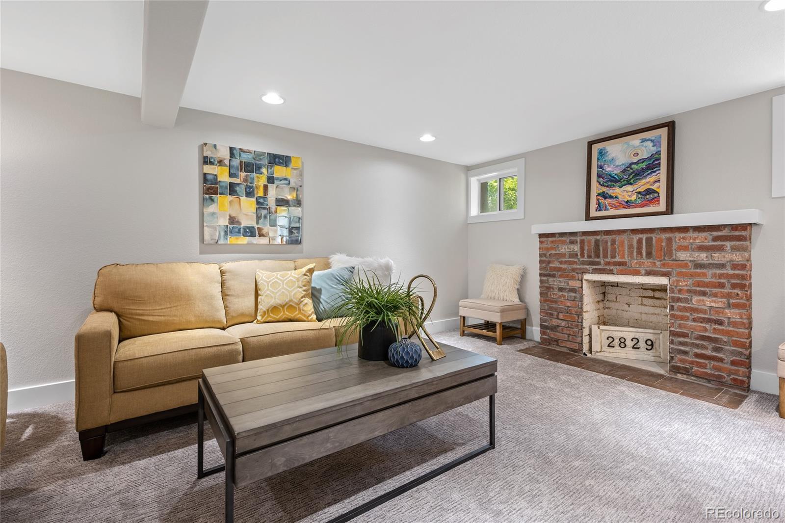 2829 Ash Street Denver, CO 80207 - Photo 28 of 40 a living room with furniture and a fireplace