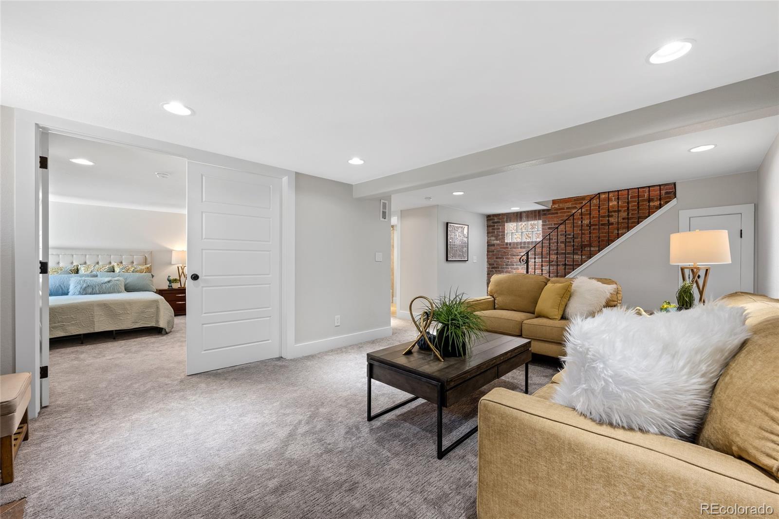 2829 Ash Street Denver, CO 80207 - Photo 29 of 40 a living room with furniture and a mirror