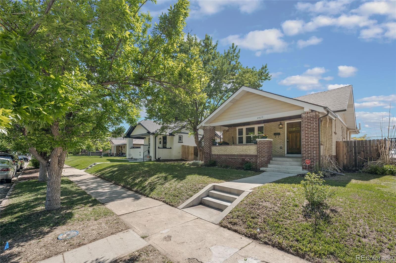 2829 Ash Street Denver, CO 80207 - Photo 3 of 40 front view of a house with a yard