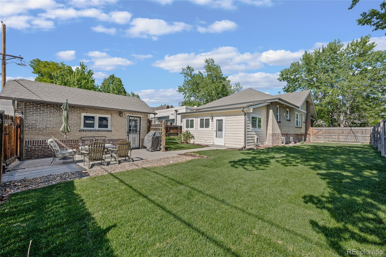 2829 Ash Street Denver, CO 80207 - Photo 36 of 40 a front view of a house with garden and porch