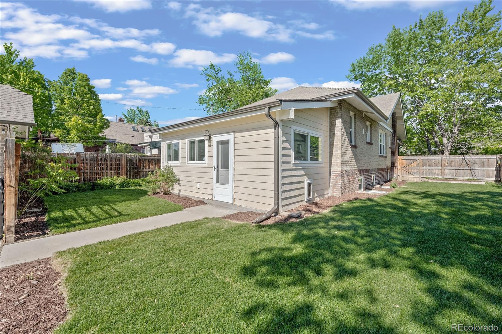 2829 Ash Street Denver, CO 80207 - Photo 37 of 40 a view of a house with a yard