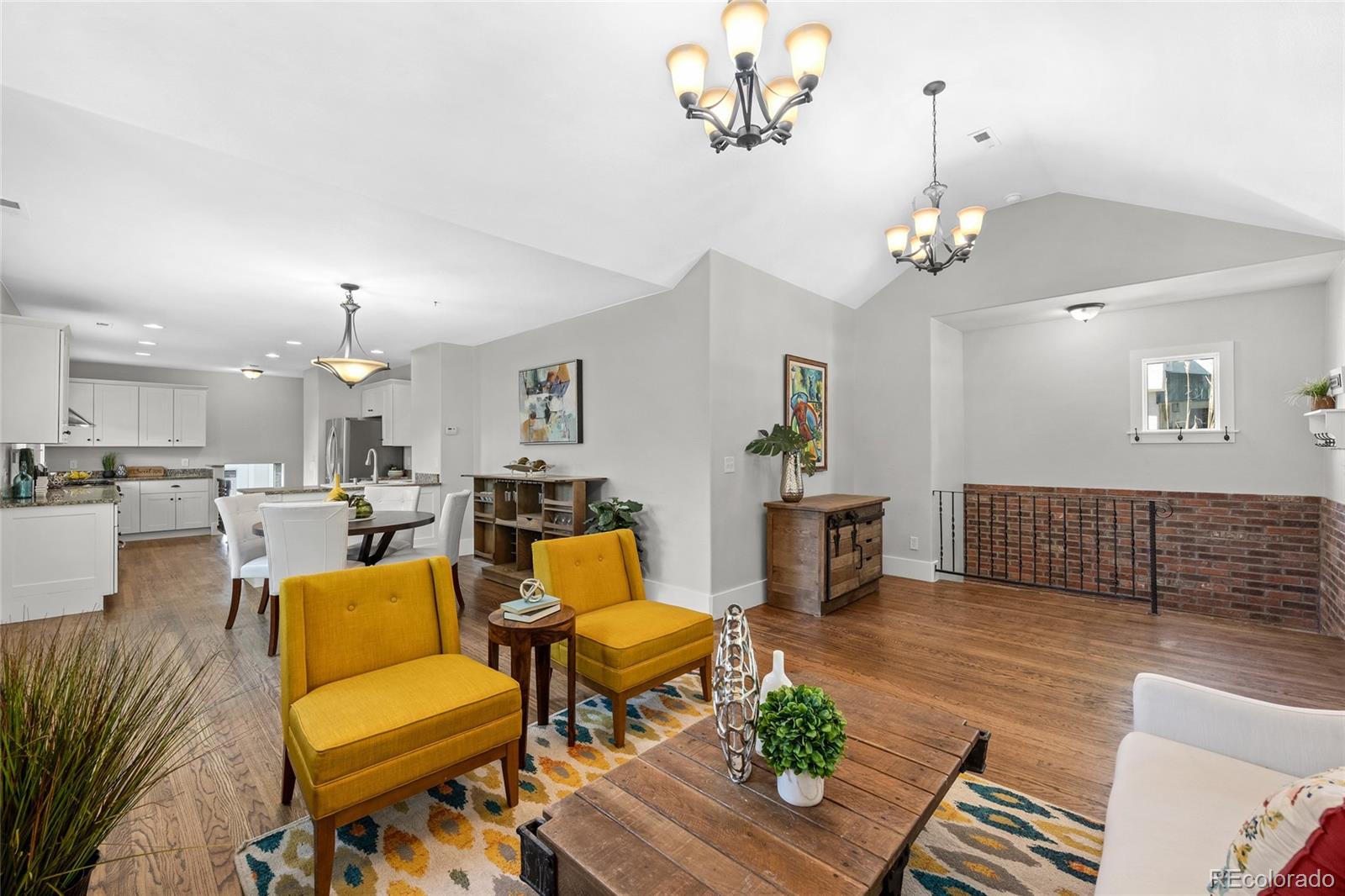 2829 Ash Street Denver, CO 80207 - Photo 8 of 40 a living room with furniture a dining table and a chandelier