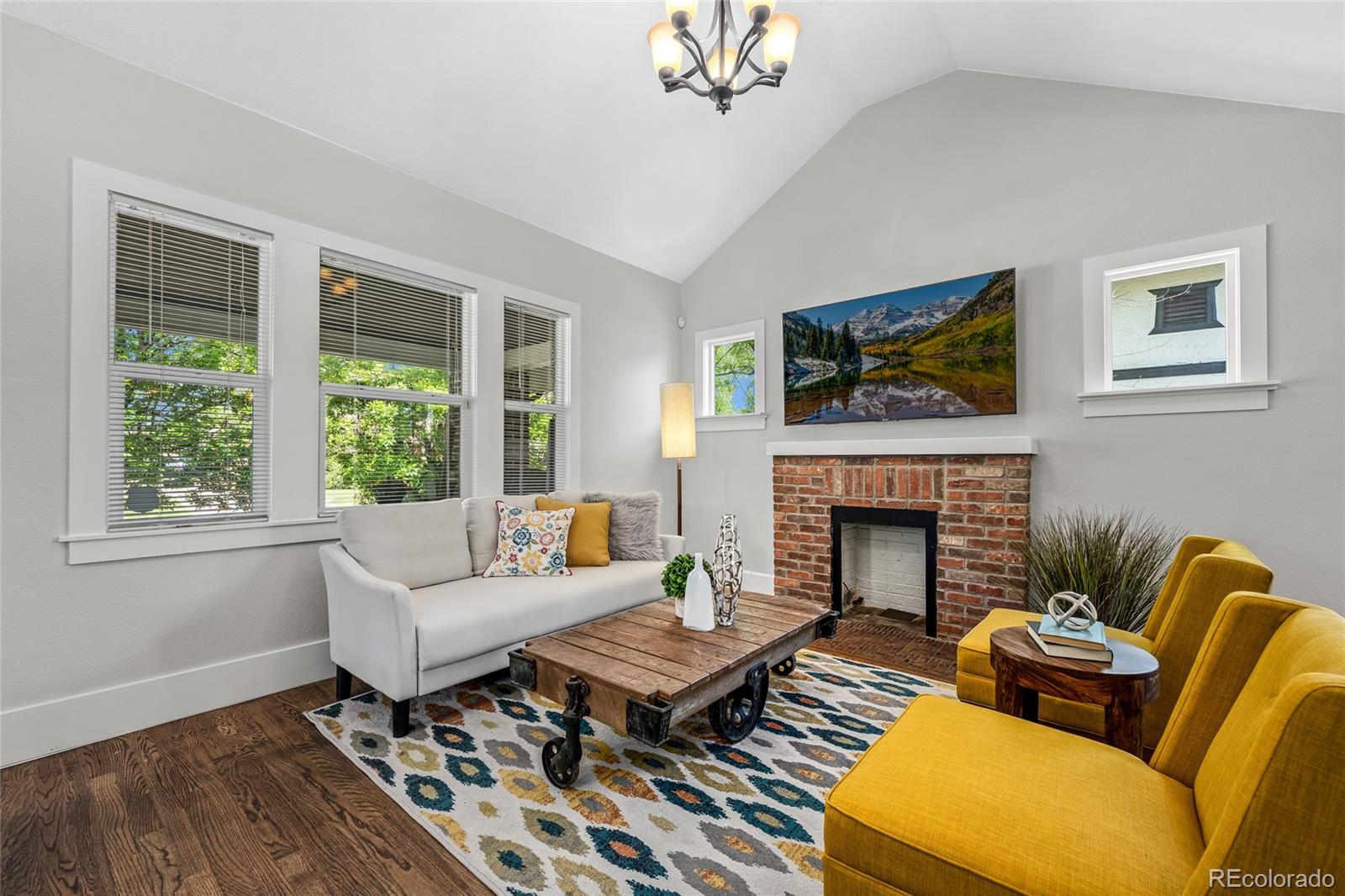 2829 Ash Street Denver, CO 80207 - Photo 9 of 40 a living room with furniture a fireplace and a flat screen tv