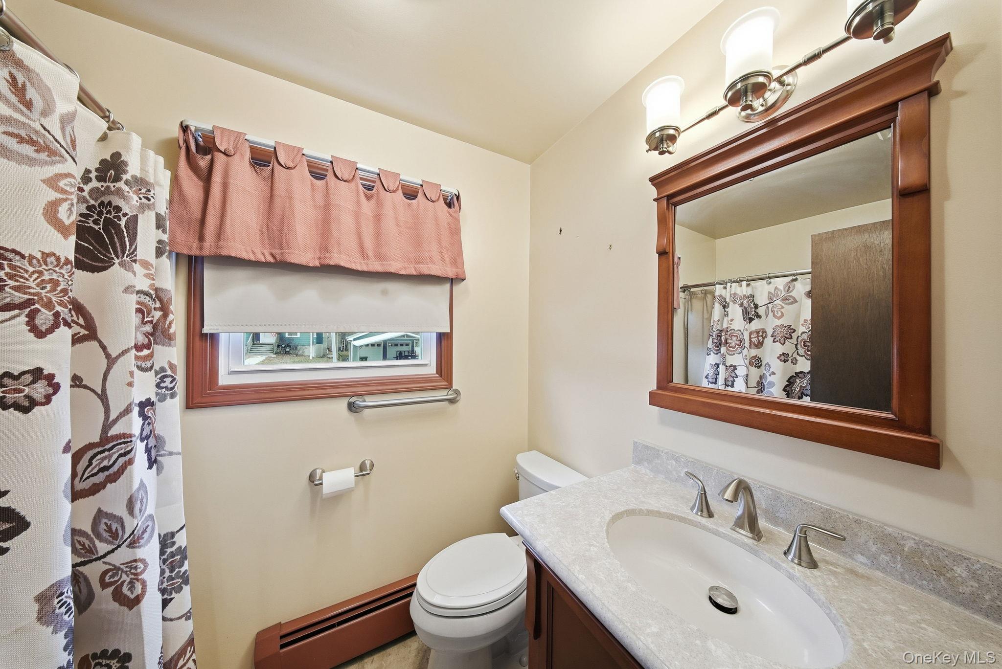 16 Mountain Avenue Middletown, NY 10940 - Photo 21 of 35 a bathroom with a sink a toilet and a mirror