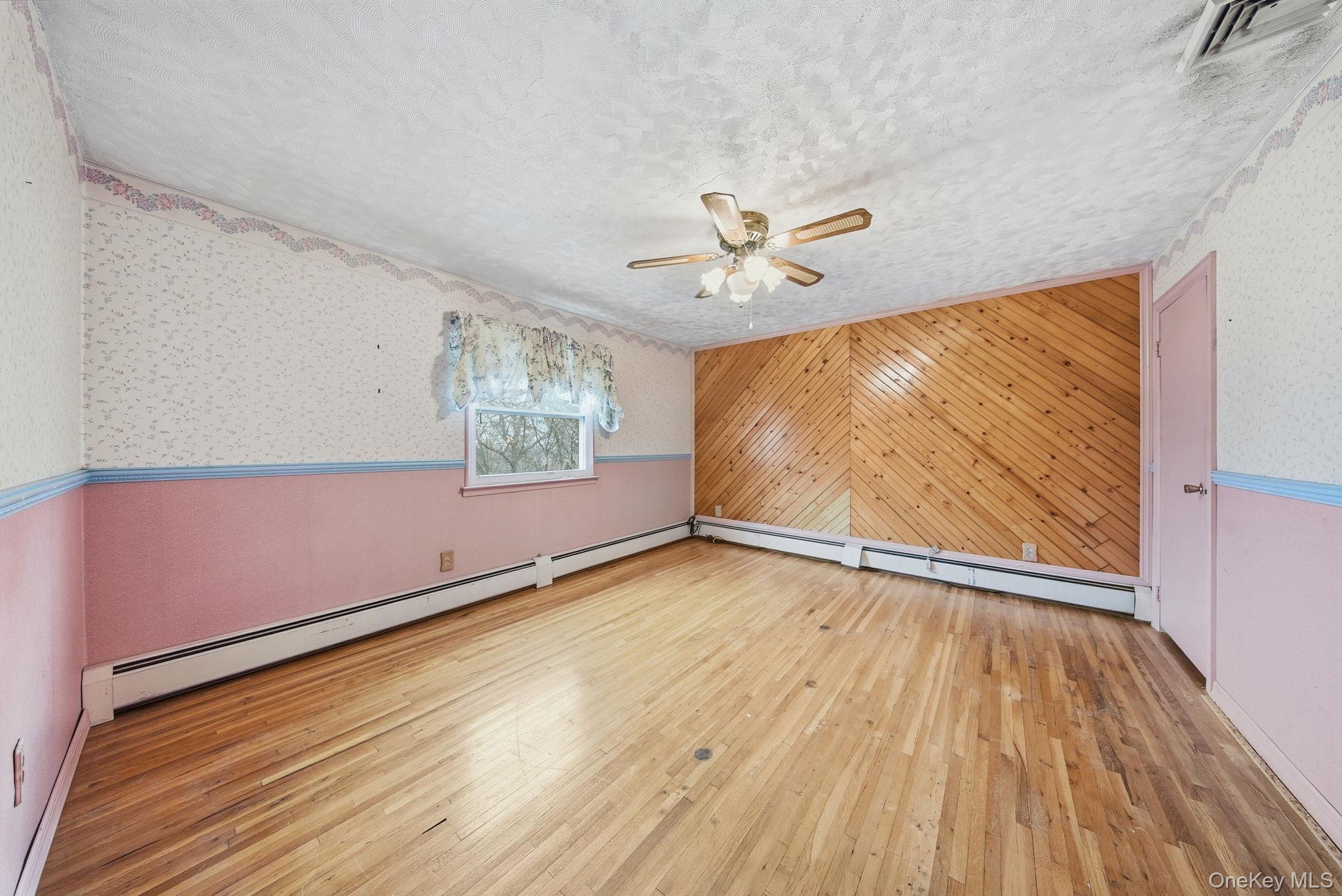 16 Mountain Avenue Middletown, NY 10940 - Photo 22 of 35 a view of an empty room with a window and wooden floor