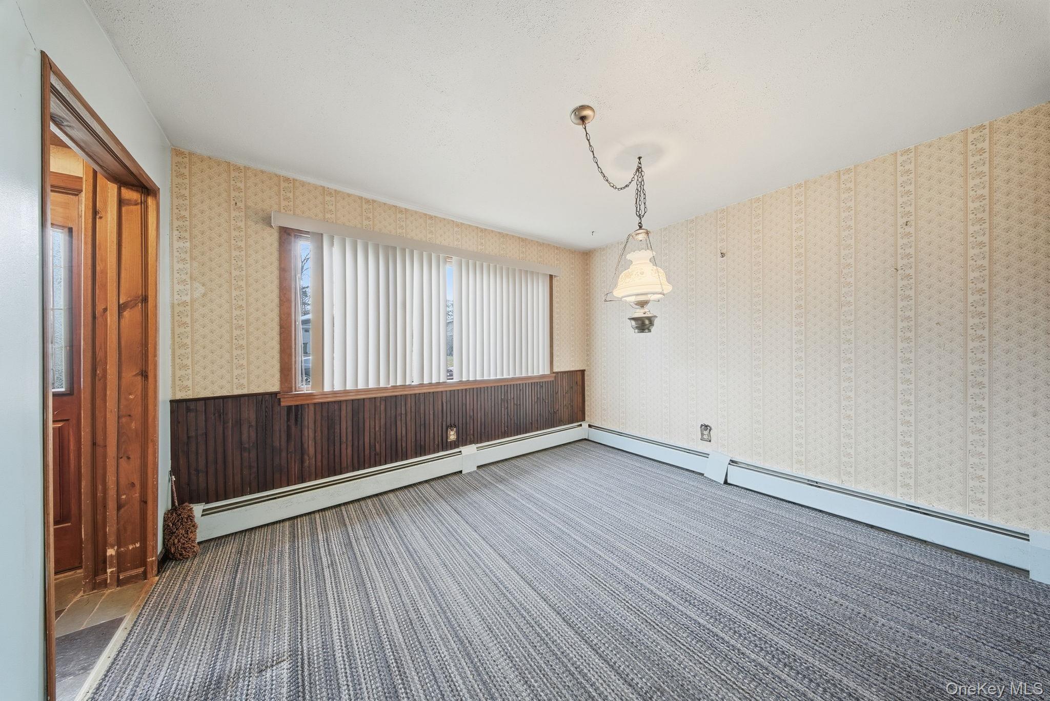 16 Mountain Avenue Middletown, NY 10940 - Photo 10 of 35 an empty room with wooden floor and windows